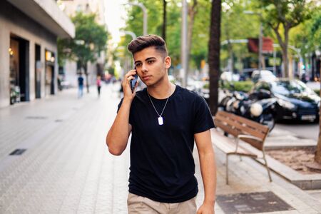 man on the street talking on a cell phoneの写真素材