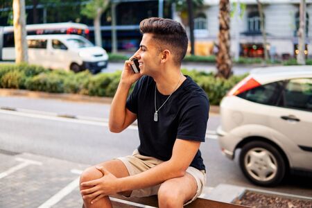 man on the street talking on a cell phoneの写真素材