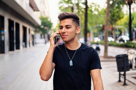 man on the street talking on a cell phoneの写真素材