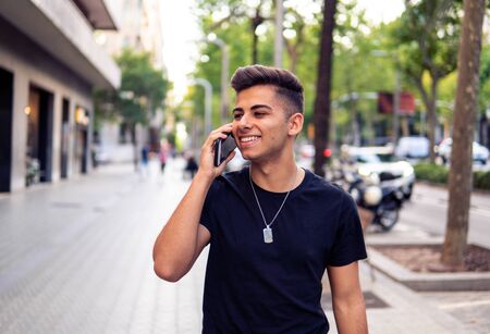 man on the street talking on a cell phoneの写真素材