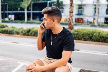 man on the street talking on a cell phoneの写真素材