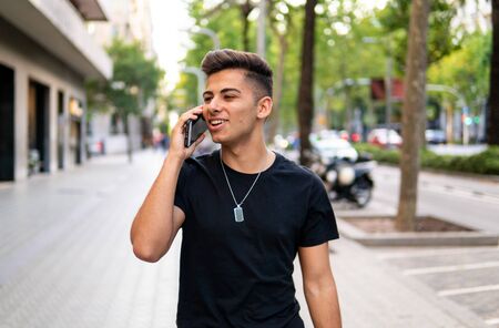 man on the street talking on a cell phoneの写真素材