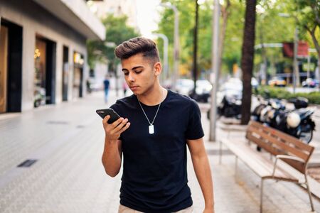 man on the street chatting on a cell phoneの写真素材