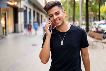 man on the street talking on a cell phoneの写真素材