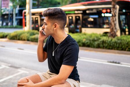 man on the street talking on a cell phoneの写真素材