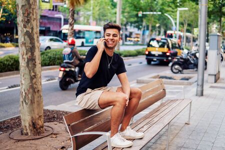 man on the street talking on a cell phoneの写真素材