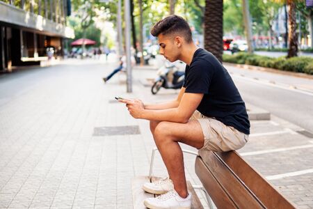 man on the street chatting on a cell phoneの写真素材