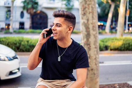 man on the street talking on a cell phoneの写真素材