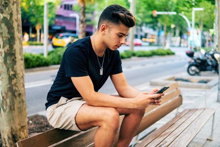 man on the street chatting on a cell phoneの写真素材