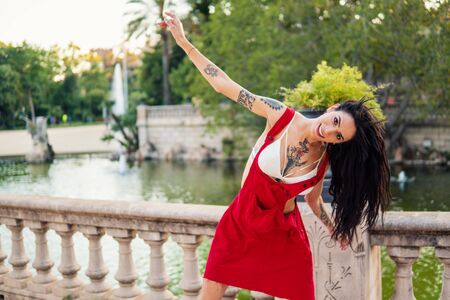 Ladyboy tattooed transgender model is dancing in the green parkの写真素材
