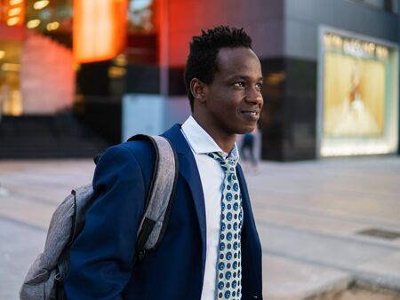 African American businessman holding laptop notebook wearing blue suitの写真素材