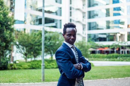 African American businessman holding laptop notebook wearing blue suitの写真素材