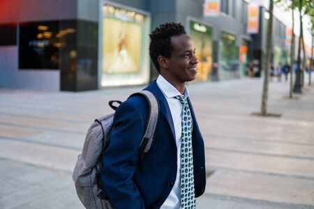 African American businessman holding laptop notebook wearing blue suitの写真素材