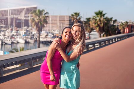 Happy best friends or sisters posing and showing lovely relationshipの写真素材