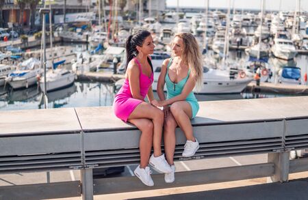 Happy best friends or sisters posing and showing lovely relationshipの写真素材