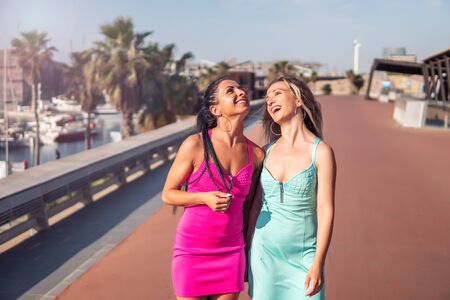 Happy best friends or sisters posing and showing lovely relationshipの写真素材