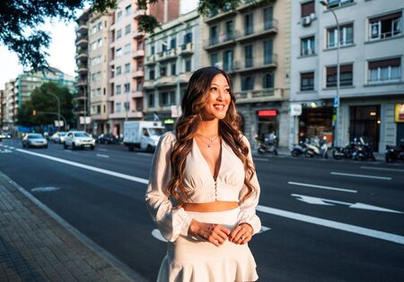 portrait of young stylish asian girl on the street of big modern cityの写真素材