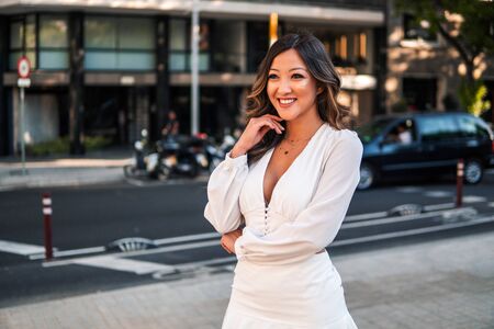 portrait of young stylish asian girl on the street of big modern cityの写真素材