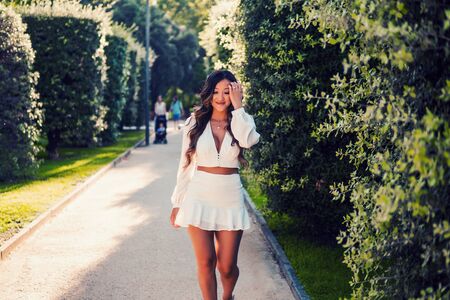 Beautiful Asian girl in white dress smiling in the parkの写真素材