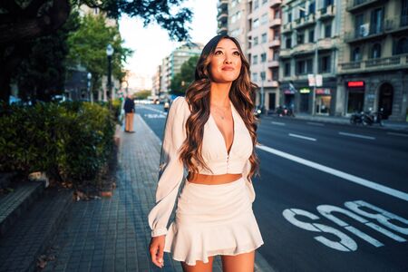 portrait of young stylish asian girl on the street of big modern cityの写真素材