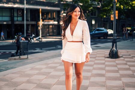 portrait of young stylish asian girl on the street of big modern cityの写真素材