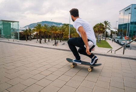 Skateboarder rides a skateboard in the modern city terrace.の写真素材