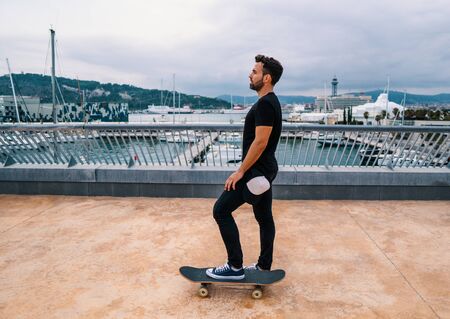 Skateboarder rides a skateboard in the modern city terrace.の写真素材