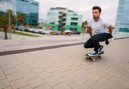Skateboarder rides a skateboard in the modern city terrace.の写真素材
