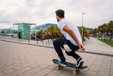 Skateboarder rides a skateboard in the modern city terrace.の写真素材