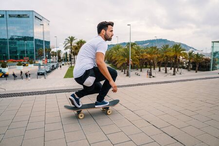 Skateboarder rides a skateboard in the modern city terrace.の写真素材
