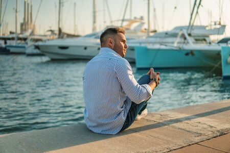 Young rich man at Yacht Club. Businessman is Relaxingの写真素材