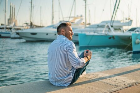 Young rich man at Yacht Club. Businessman is Relaxingの写真素材