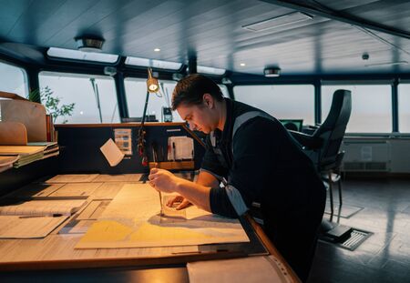 Marine navigational officer during navigational watch on Bridgeの写真素材