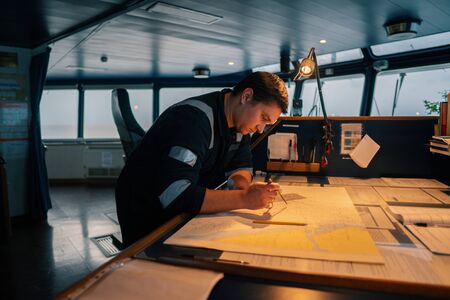 Marine navigational officer during navigational watch on Bridgeの写真素材
