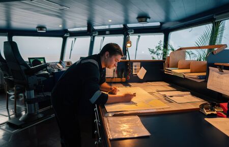 Marine navigational officer during navigational watch on Bridgeの写真素材