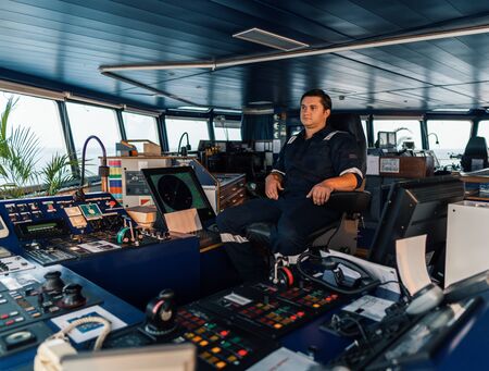 Marine navigational officer during navigational watch on Bridge . Work at seaの写真素材