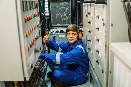 Marine engineer inspecting ships engine or generatorsの写真素材