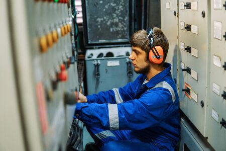 Marine engineer inspecting ships engine or generators
