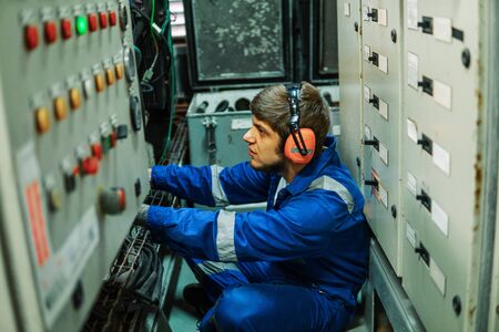 Marine engineer inspecting ships engine or generatorsの写真素材