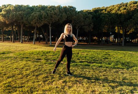 Sport training in city park. Beautiful runner woman posingの写真素材