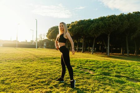 Sport training in city park. Beautiful runner woman posingの写真素材