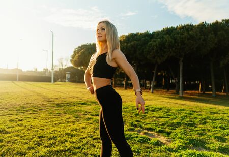 Sport training in city park. Beautiful runner woman posingの写真素材