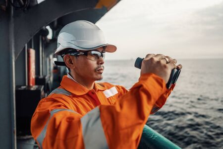 Filipino deck Officer on deck of vessel or ship , wearing PPE personal protective equipmentの写真素材