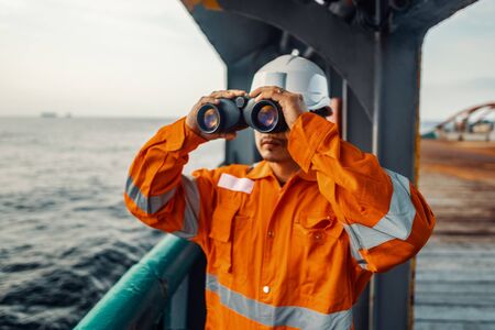 Filipino deck Officer on deck of vessel or ship , wearing PPE personal protective equipmentの写真素材