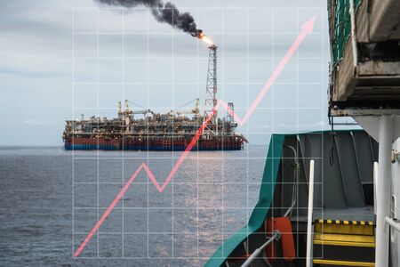 Concept of growth up in offshore marine industry with rising graphics. Oil price increases. FPSO tanker vessel on oilfieldの写真素材