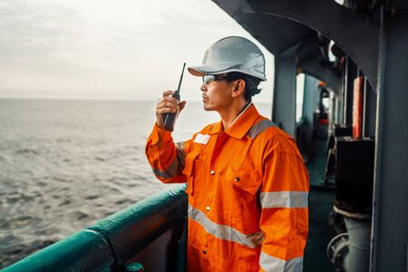 Filipino deck Officer on deck of vessel or ship , wearing PPE personal protective equipmentの写真素材
