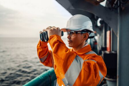 Filipino deck Officer on deck of vessel or ship , wearing PPE personal protective equipmentの写真素材