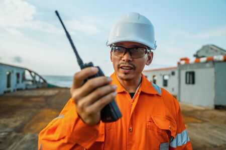 Filipino deck Officer on deck of vessel or ship , wearing PPE personal protective equipmentの写真素材