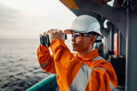 Filipino deck Officer on deck of vessel or ship , wearing PPE personal protective equipmentの写真素材