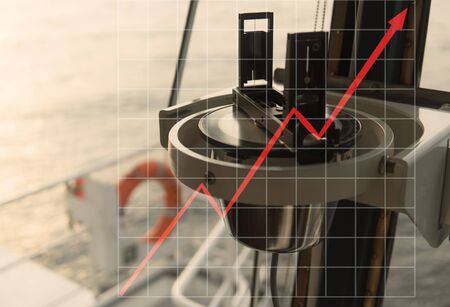 Concept of growth up in marine industry with rising graphics. Magnetic compassの写真素材